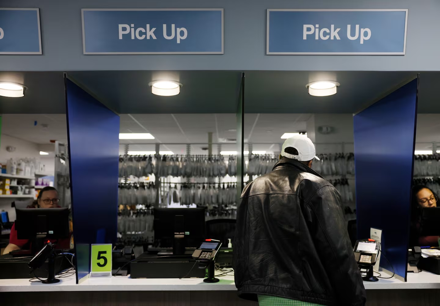 A patient picks up a prescription at Brockton Neighborhood Health Center’s pharmacy in 2024